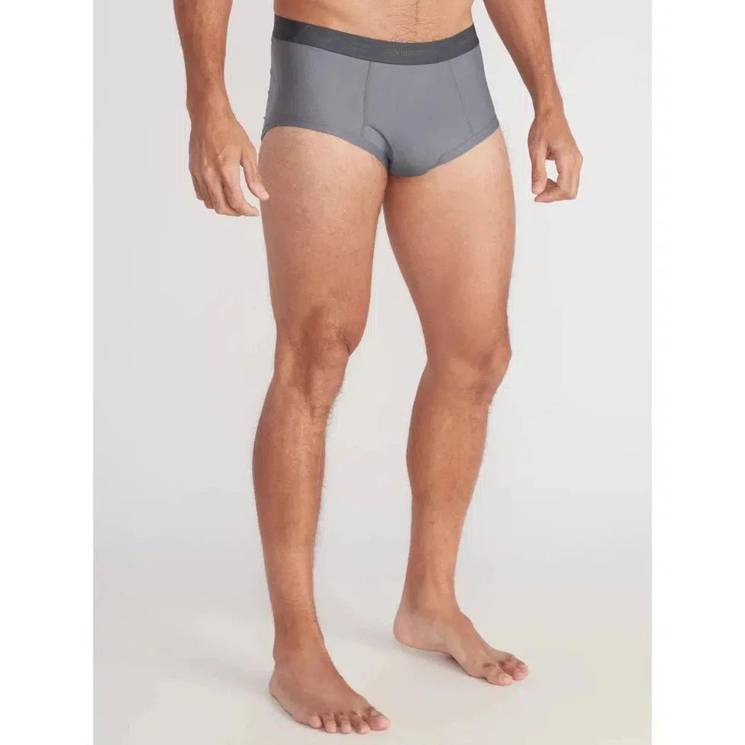 A front view of the Exofficio Men's Give-N-Go 2.0 Brief in Black on a barefoot model against a plain white background.