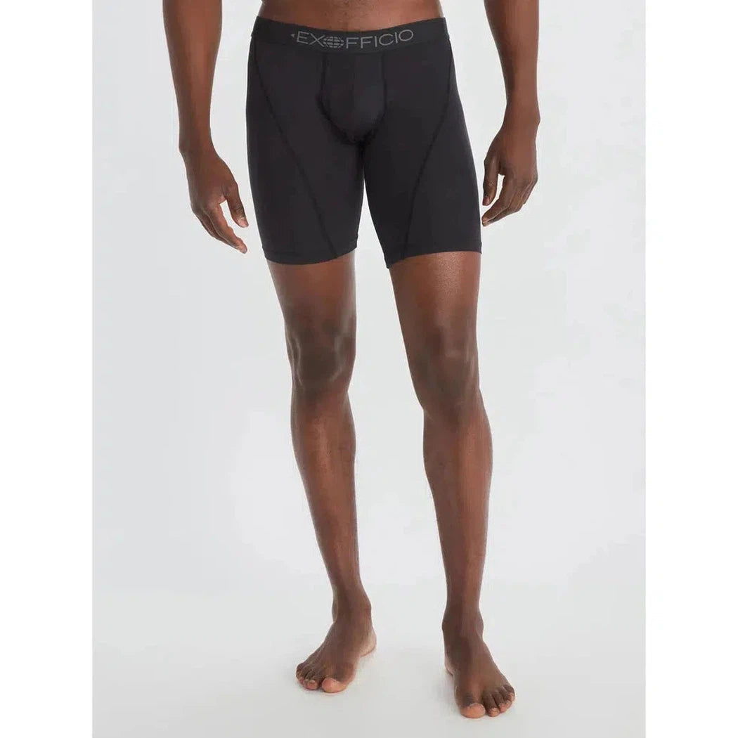 A front view of a Black/Black Exofficio Men's Give-N-Go Sport 2.0 Boxer Brief 9" on a barefoot model against a white background.