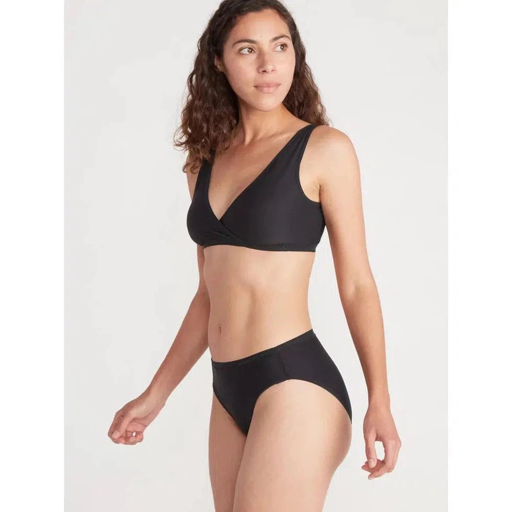 A model wearing the Exofficio Women's Give-N-Go 2.0 Bikini Brief in Bellini Mosaic stands against a plain white background.