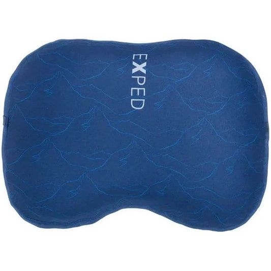 A blue Exped DeepSleep Pillow M with a mountain print pattern is shown from a top-down angle against a white background.