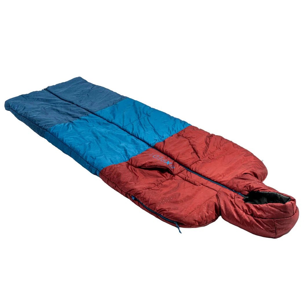 A side view of the Exped Dreamwalker Burgundy sleeping bag showing the hood and zipper against a white background.