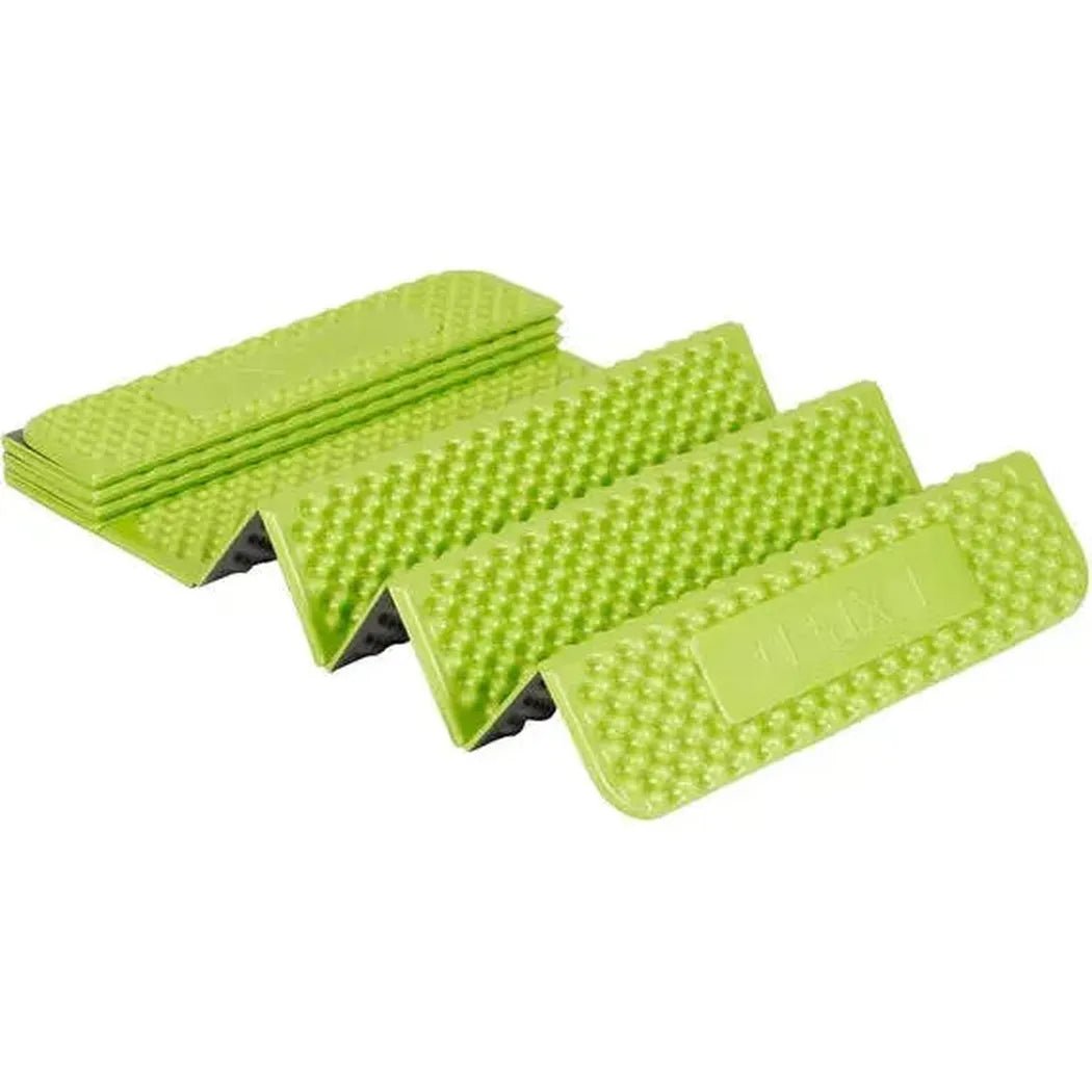 Four green Exped Flex 1.5R sleeping pads are stacked and spread out, showing their textured surface and a white background.