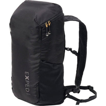 A side view of the black Exped Summit Lite 15 backpack showing its shoulder straps and front pocket against a white background.