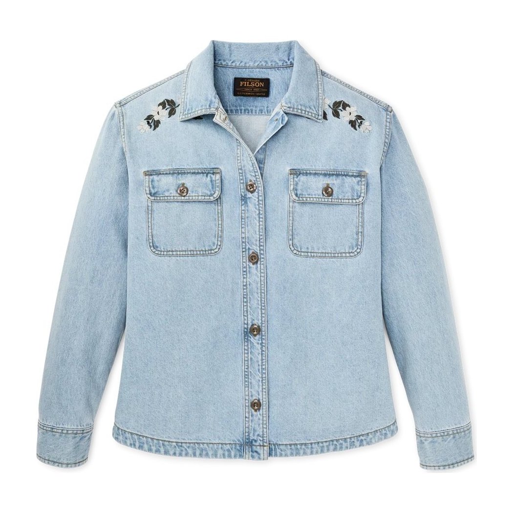 A front view of the Filson Womens Denim Shirt in Pale Indigo showing the embroidered shoulder details and button front against a white background.