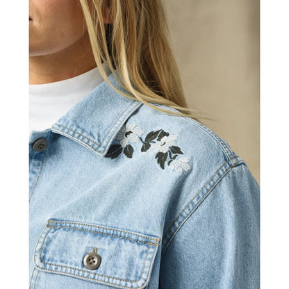 A close-up of the Filson Womens Denim Shirt in Pale Indigo showing the embroidered shoulder detail and chest pocket.