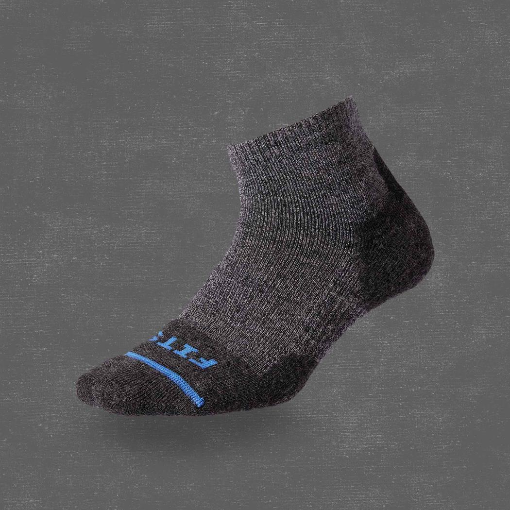 Side view of the FITS Light Hiker Quarter in Coal showing the blue stripe and heel on a gray background.