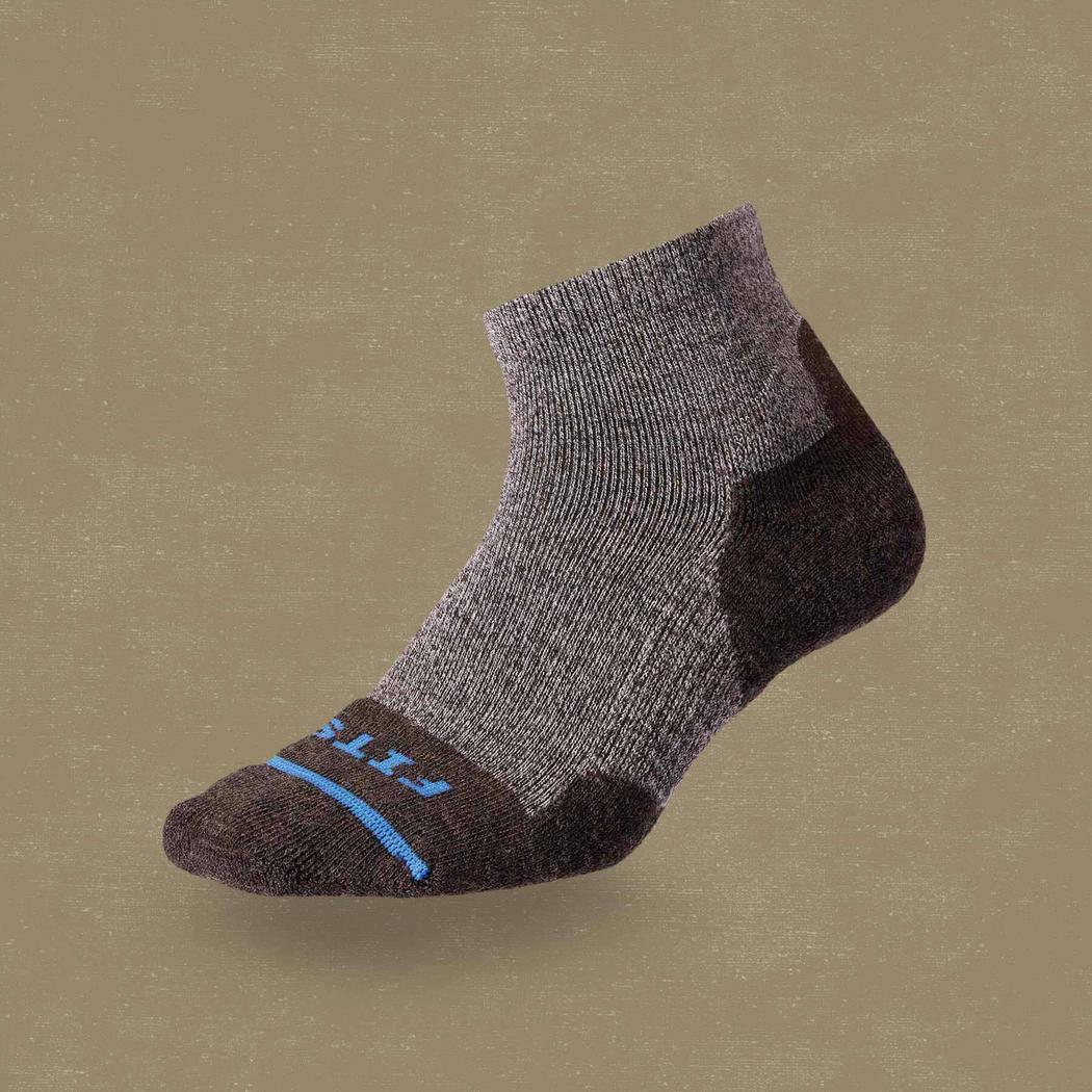 Side view of the FITS Light Hiker Quarter Coal socks showing the heel and toe padding against a neutral background.