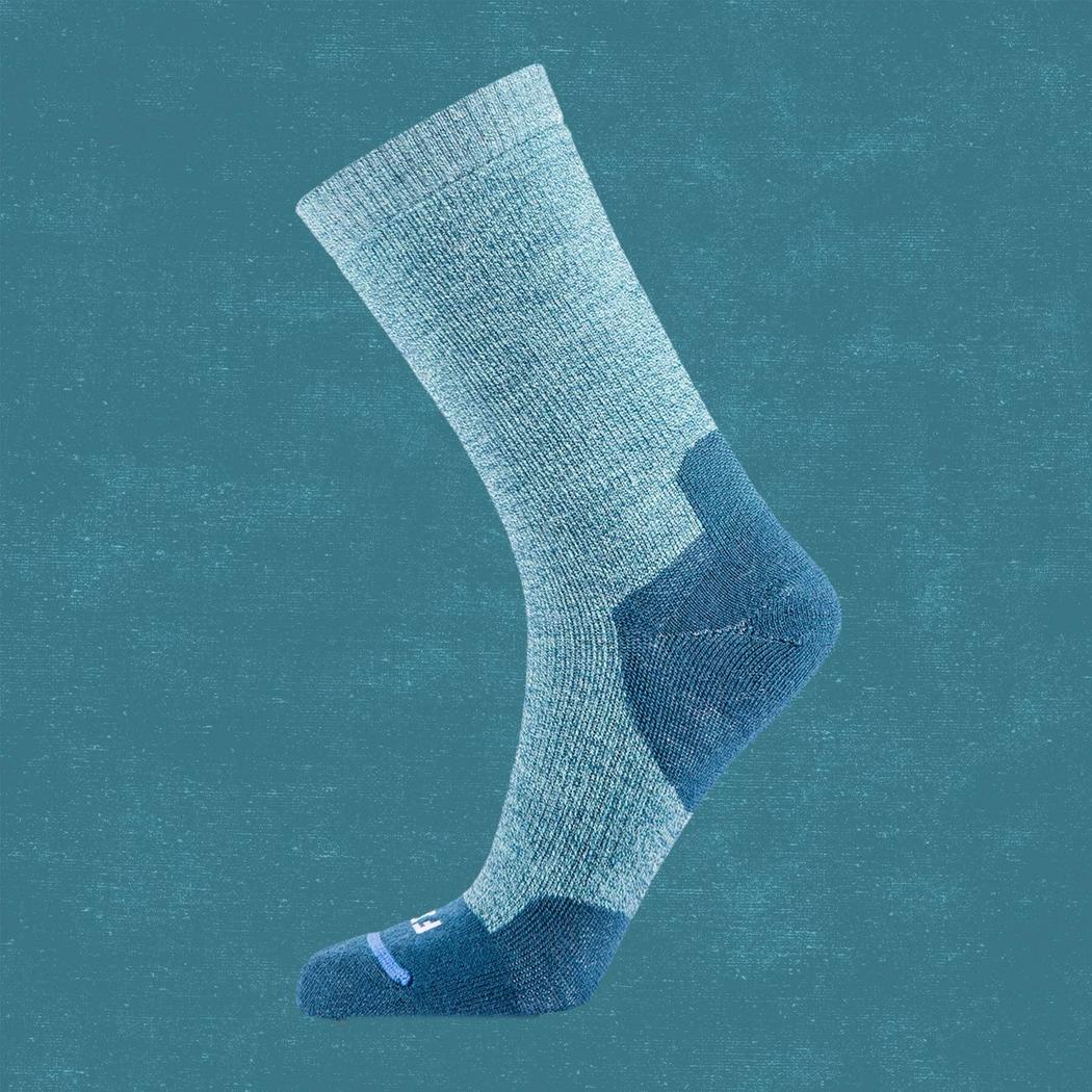 Side view of the FITS Medium Hiker Crew in Coal showing the reinforced heel and toe against a teal background.