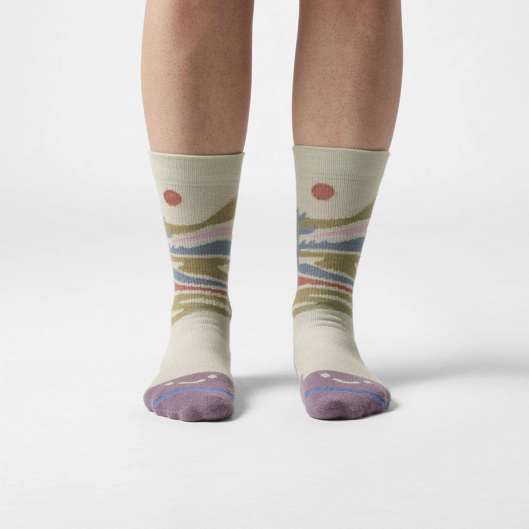 A front view of the FITS Space Desert Original Fit Light Crew socks in Desert Sage on a model against a white background.