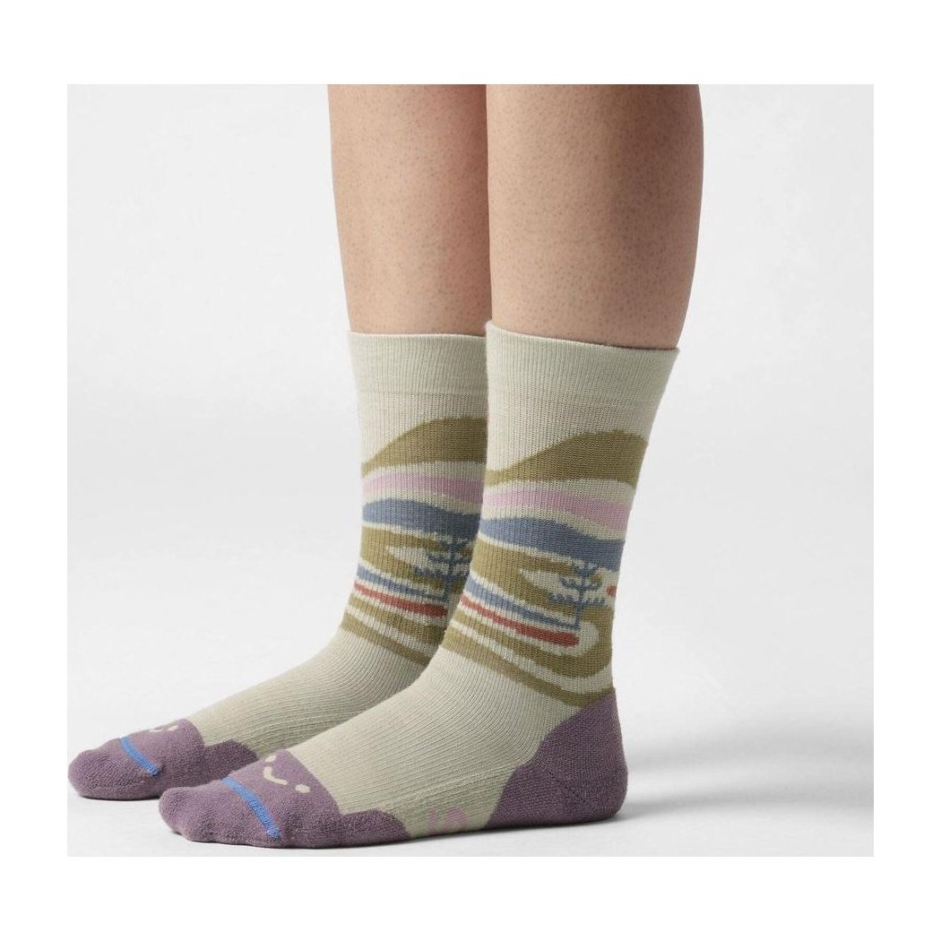 A side view of the FITS Space Desert Original Fit Light Crew socks in Desert Sage on a model's feet against a white background.