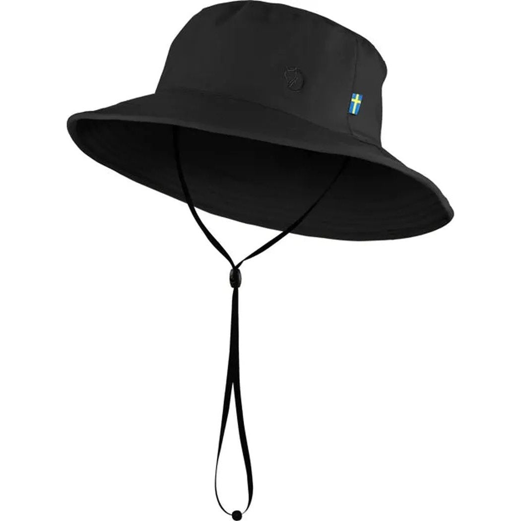 A black Fjallraven Abisko Sun Hat with a chin strap, shown from the front against a white background.