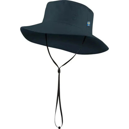 A front view of the Fjallraven Abisko Sun Hat in Black with a chin strap and a small logo on the side, against a white background.