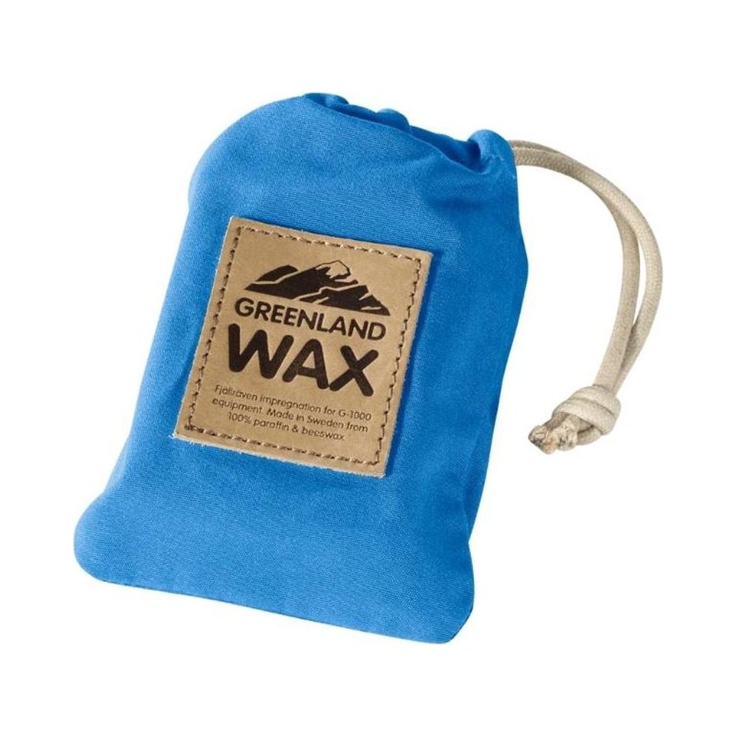 A blue Fjallraven Greenland Wax Bag with a drawstring closure and a tan label showing the brand name.