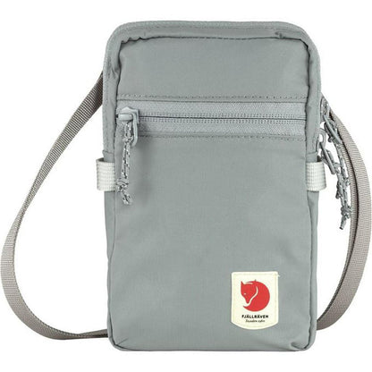 A front view of the Fjallraven High Coast Pocket in Black with a shoulder strap and zippered pocket, against a white background.