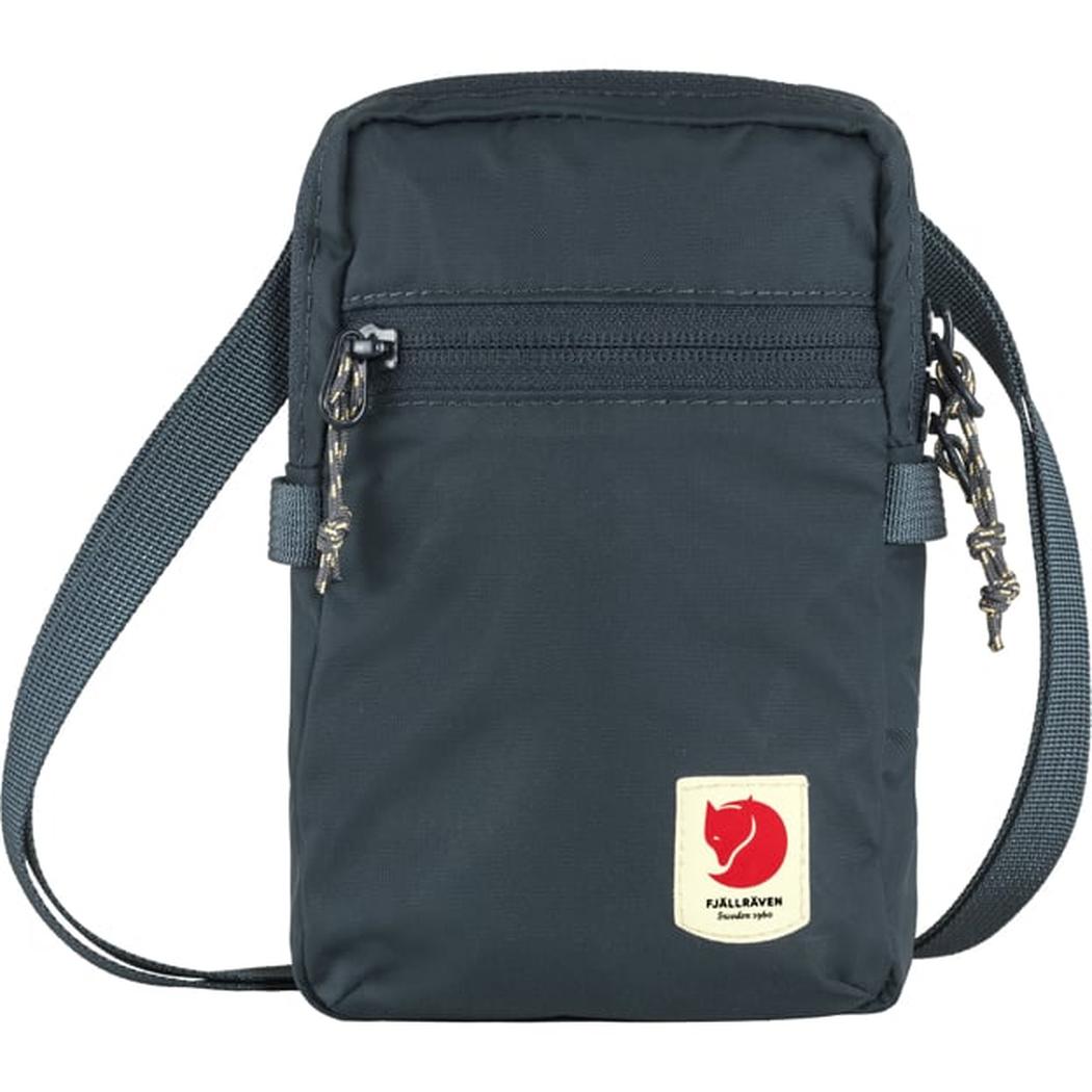 A front view of the Fjallraven High Coast Pocket in Black showing the zippered front pocket and adjustable shoulder strap against a white background.
