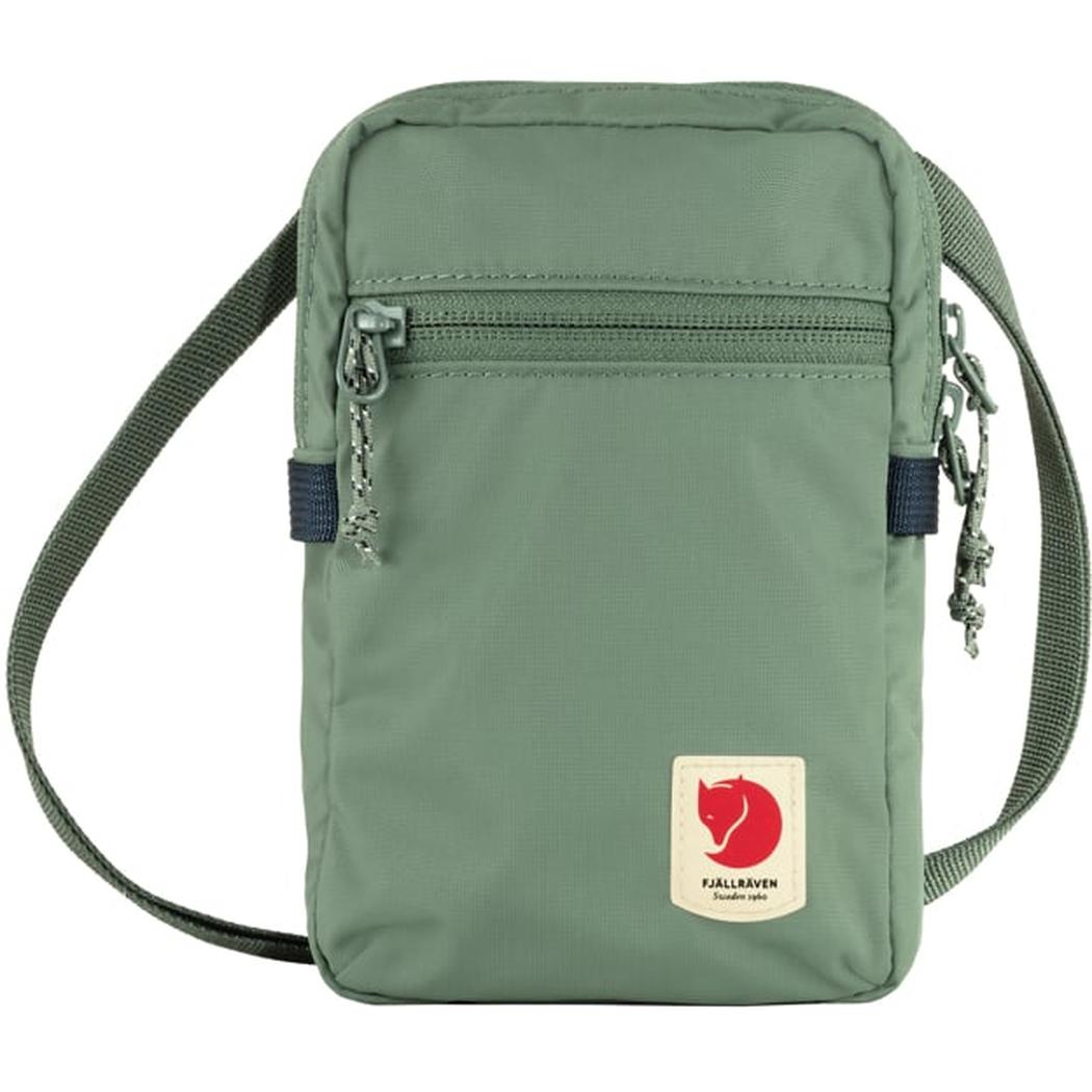 A front view of the Fjallraven High Coast Pocket in Black with a zippered top pocket and adjustable shoulder strap against a white background.