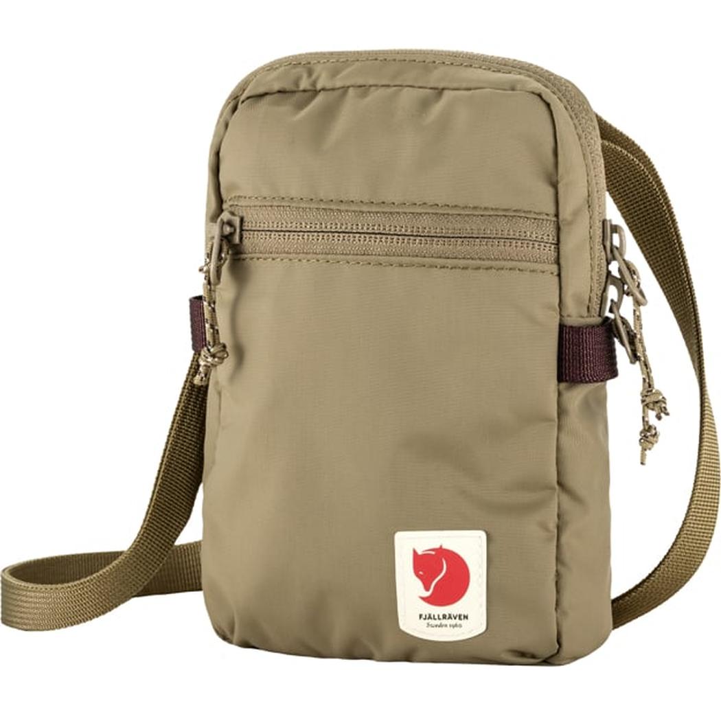 A front view of the Fjallraven High Coast Pocket in Black with a zippered top pocket and adjustable strap against a white background.