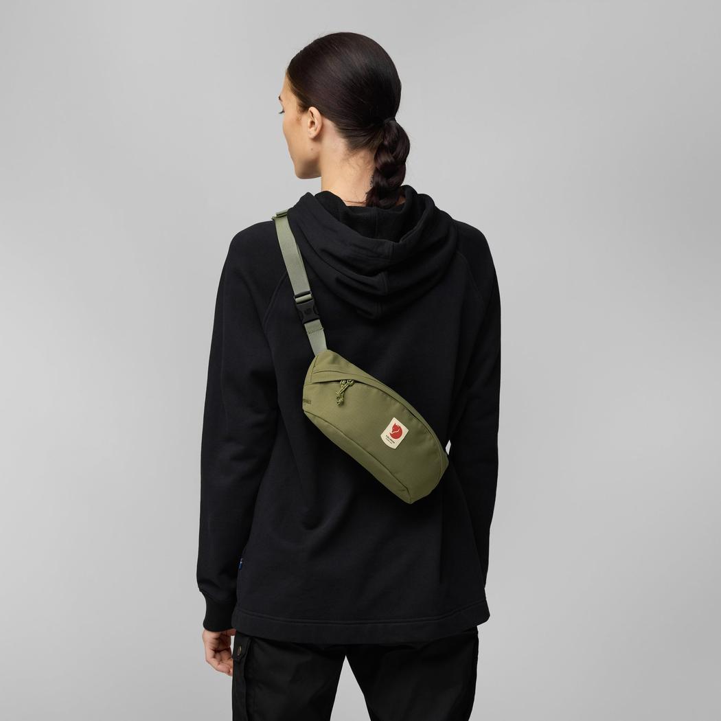 Back view of the Fjallraven Ulvo Hip Pack Medium in Black on a model against a gray background.
