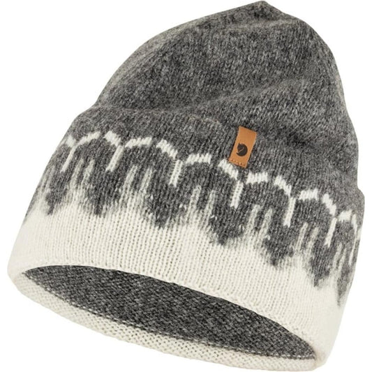 A front view of the Fjallraven Övik Path Knit Beanie in Chalk White Grey showing the pattern and a leather tag on the side.
