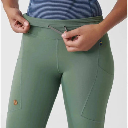 Side view of the Fjallraven Women's Abisko Tights in Patina Green showing the drawstring waist and pocket details.