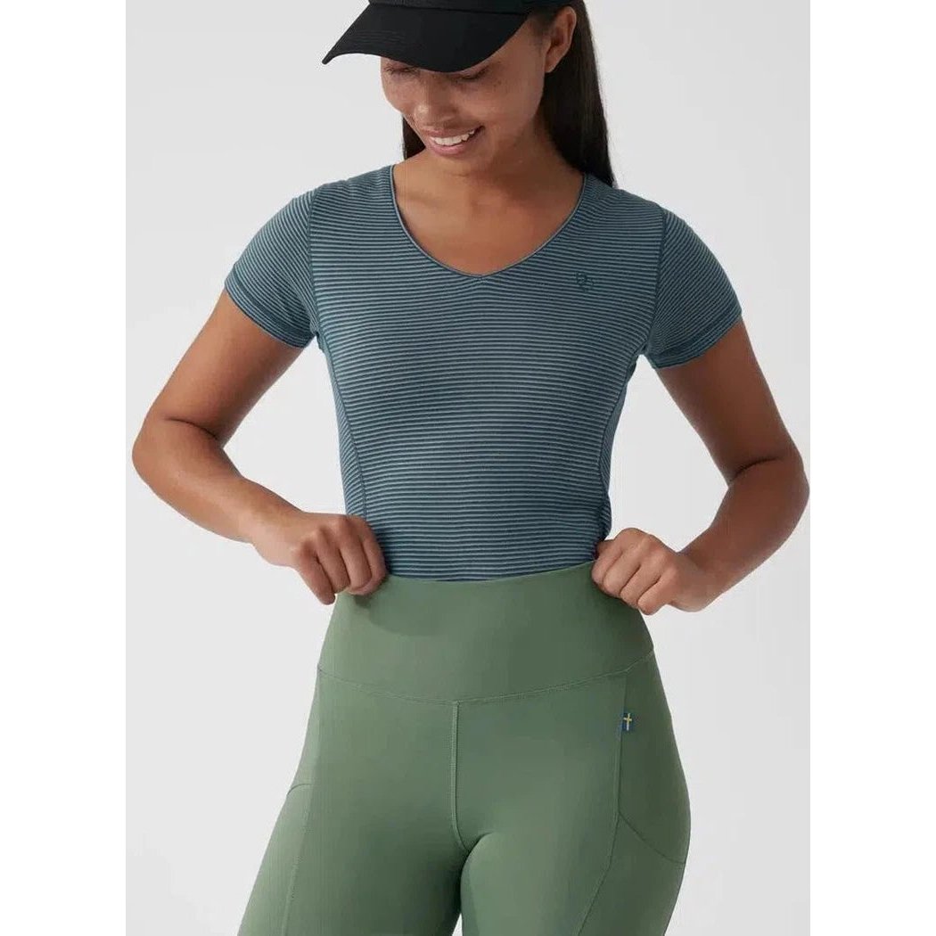 A model wearing Fjallraven Women's Abisko Tights in Patina Green stands against a plain white background.