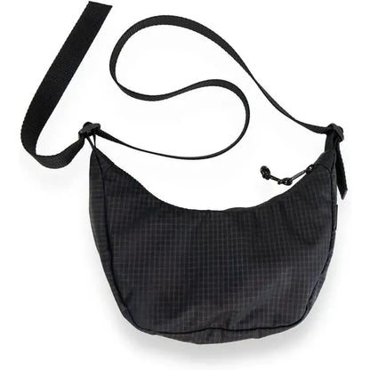 A black Flowfold Mini Culter Crossbody bag with an adjustable strap, shown from a top-down angle against a white background.