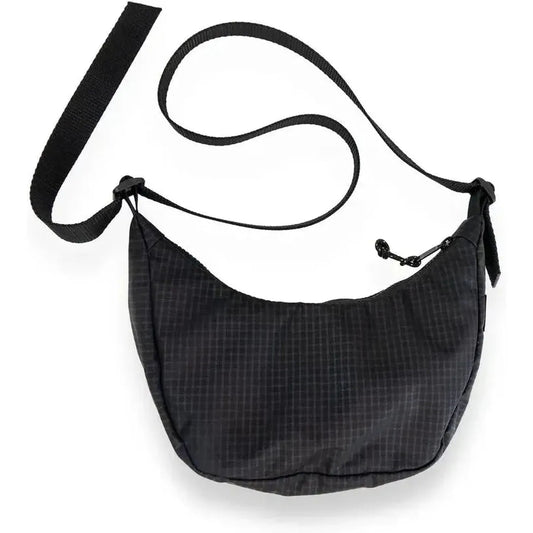 A black Flowfold Mini Culter Crossbody bag with an adjustable strap, shown from a top-down angle against a white background.