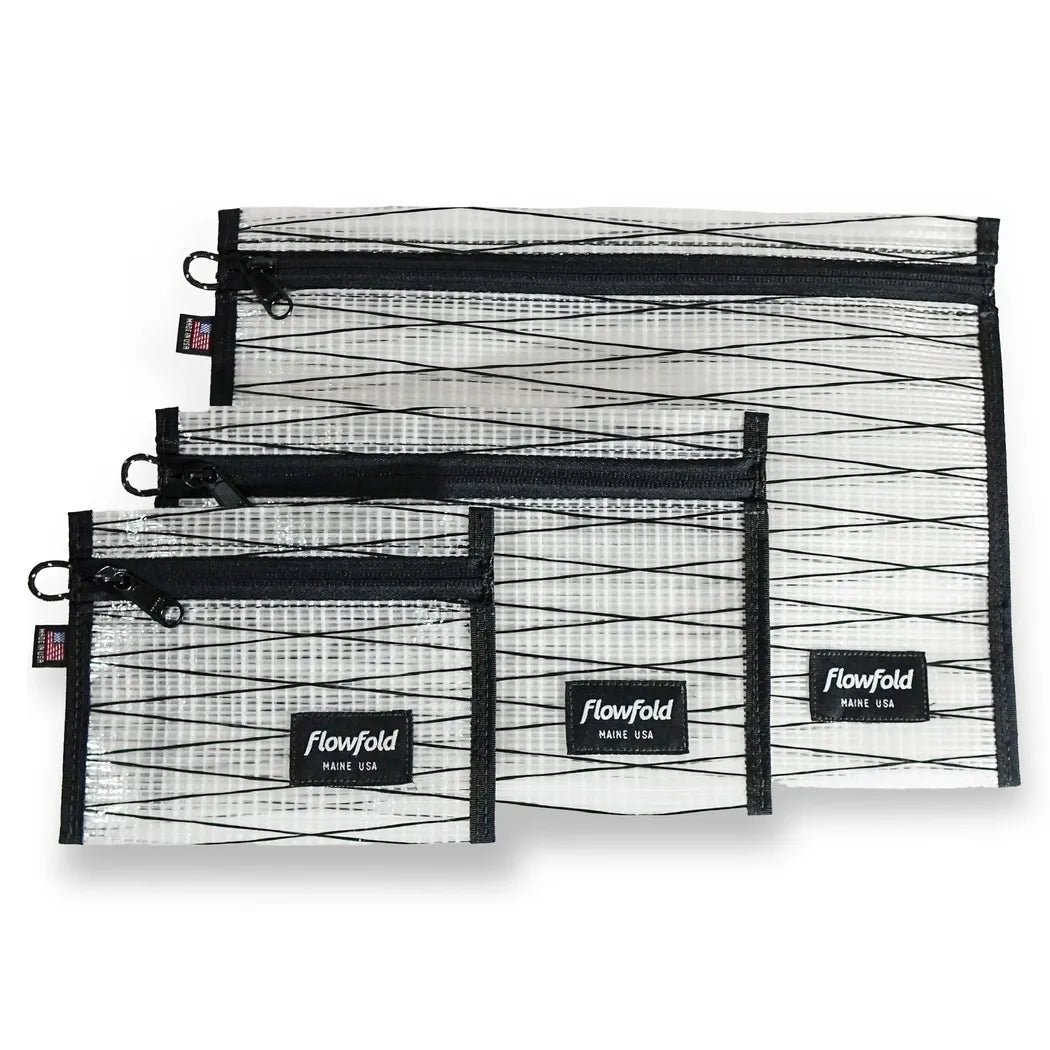 Three black sailcloth Flowfold zipper pouches in varying sizes are displayed against a white background.