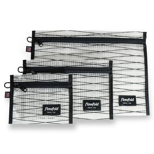 Three black sailcloth Flowfold zipper pouches in varying sizes are displayed against a white background.