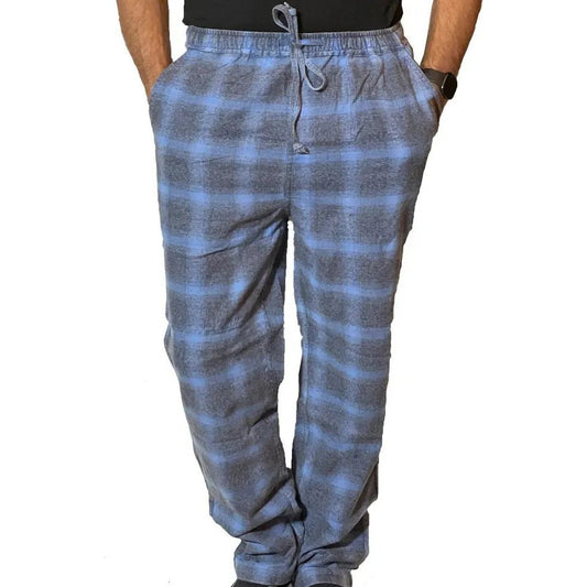 A front view of the Flyshacker Men's Flyshacker Cabin Jams in Dusty Blue with a drawstring waist and pockets, worn by a model against a white background.