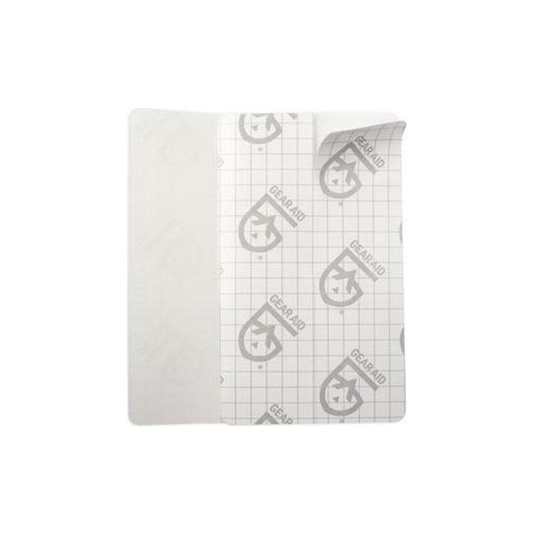 A close-up of the Gear Aid Tenacious Tape Flex Patches with a grid-patterned backing and a white adhesive side, displayed against a plain white background.