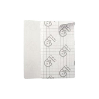 A close-up of the Gear Aid Tenacious Tape Flex Patches with a grid-patterned backing and a white adhesive side, displayed against a plain white background.