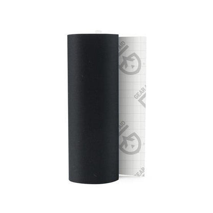 A roll of black Gear Aid Tenacious Tape Repair Tape with a white backing visible behind it.