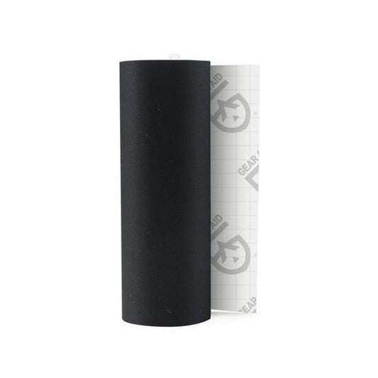 A roll of black Gear Aid Tenacious Tape Repair Tape with a white backing visible behind it.