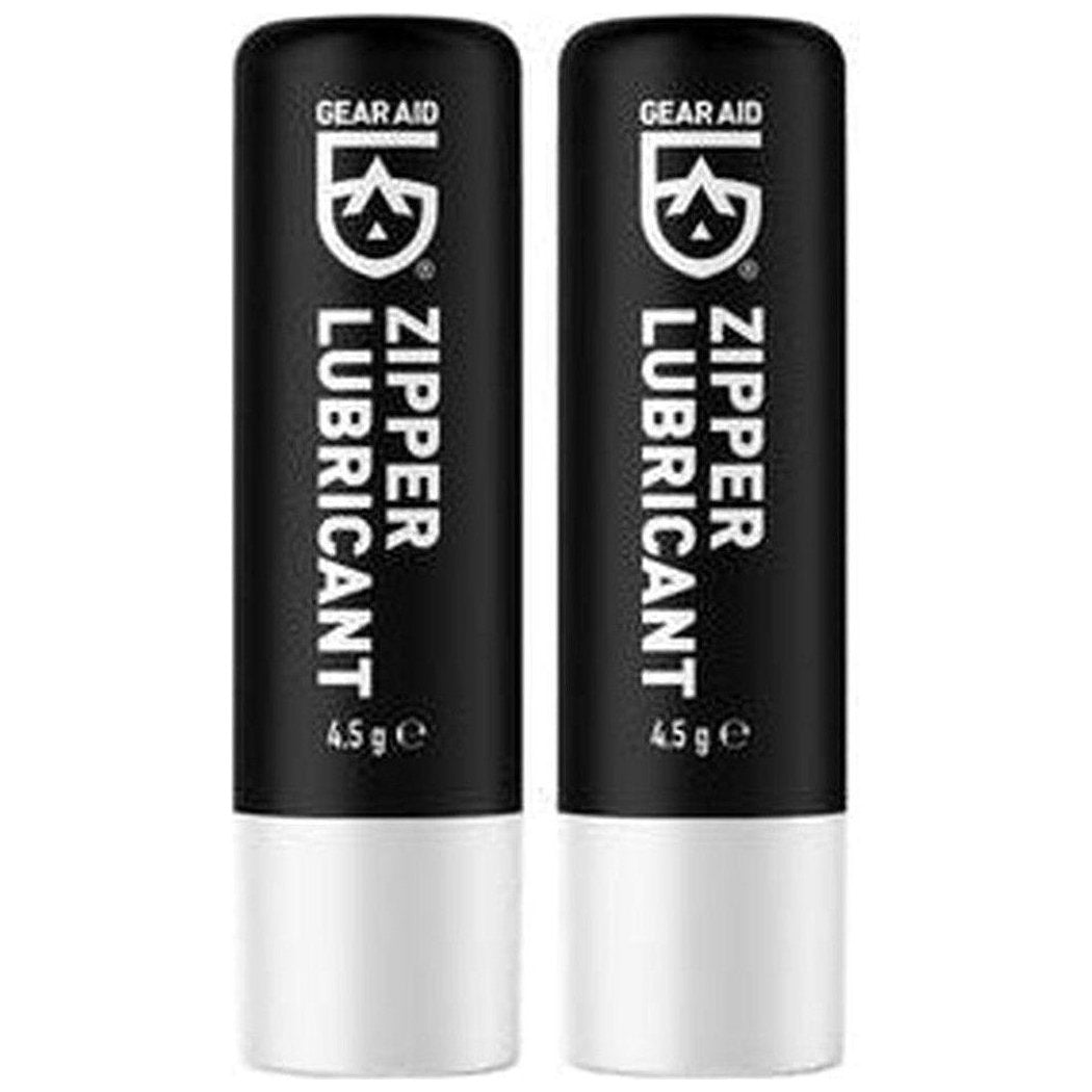 Two black and white Gear Aid Zipper Lubricant Sticks, 4.5g each, side by side against a white background.
