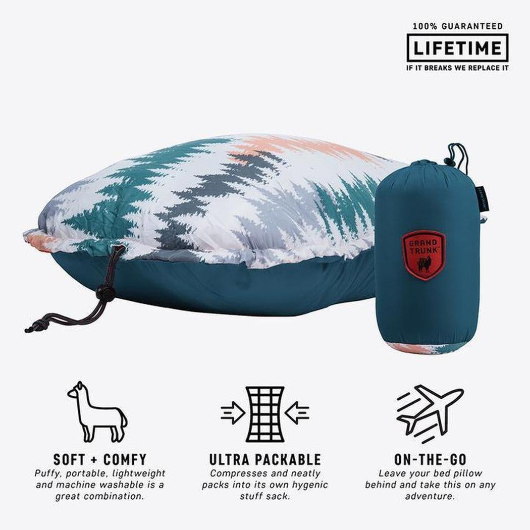 A side view of the Grand Trunk Adjustable Travel Pillow in Peacock Green showing the pillow and its stuff sack against a white background.