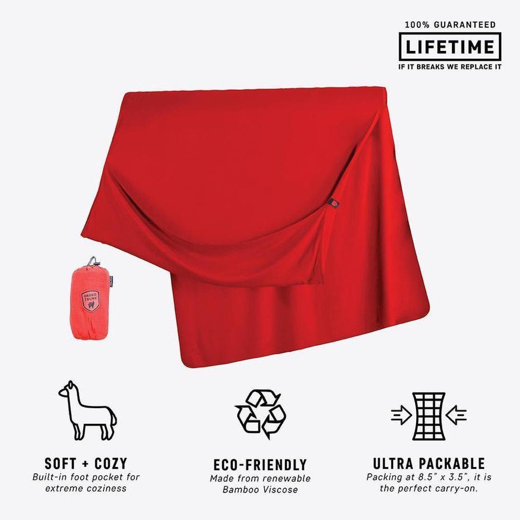 A red Grand Trunk Bamboo Travel Blanket laid flat with a small red pouch and icons showing its features.