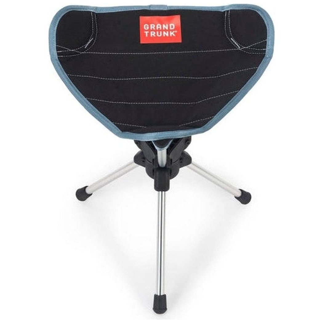 A front view of the Grand Trunk Compass 360 Stool in Black showing the tripod base and red Grand Trunk logo on the seat.