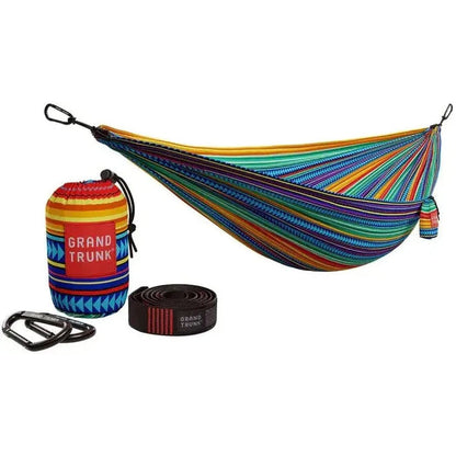 A colorful Grand Trunk Double Deluxe Hammock with suspension straps and accessories displayed against a white background.