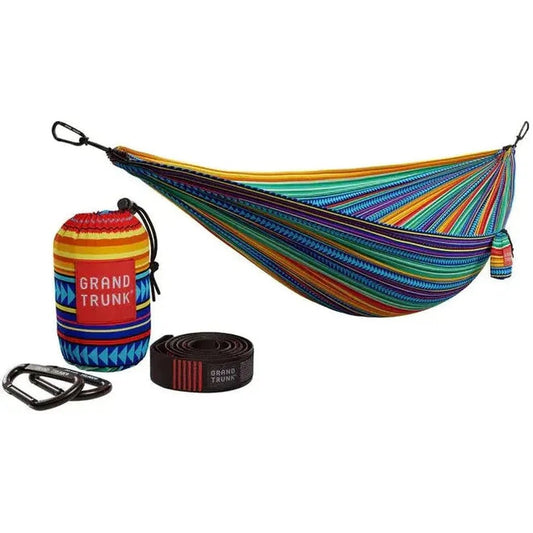 A colorful Grand Trunk Double Deluxe Hammock with suspension straps and accessories displayed against a white background.