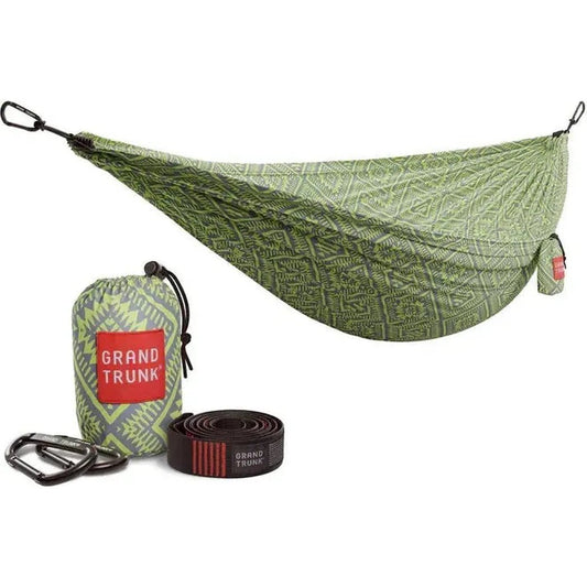 A green Grand Trunk Double Deluxe Hammock with suspension straps and a matching bag displayed on a white background.