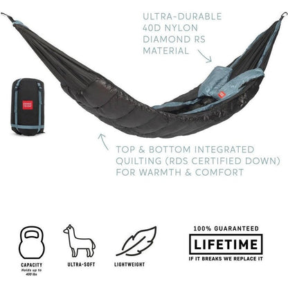 A charcoal Grand Trunk Evolution Down Hammock laid out with its compact bag visible, showing top and bottom quilting for warmth.