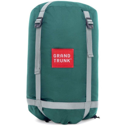 A front view of the Grand Trunk Evolution Synthetic Hammock in forest green with gray straps and a red logo patch against a white background.