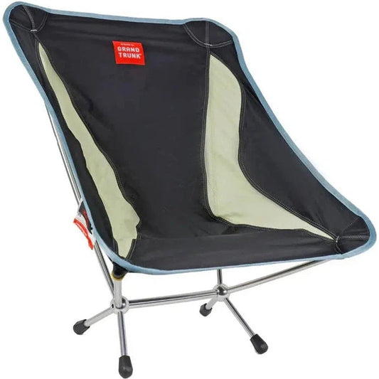 A side view of the Grand Trunk Mantis camping chair in Black with a light green accent panel and a silver metal frame.