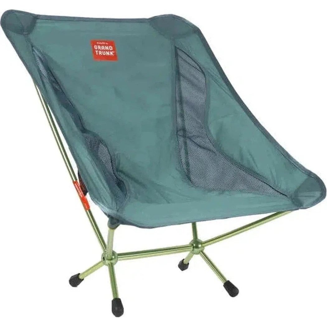 A side view of the Grand Trunk Mantis camping chair in Black with a mesh seat and metal frame against a white background.