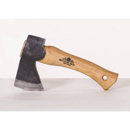 A side view of the Gransfors Bruk Hand Hatchet with a wooden handle and a charcoal-colored blade against a white background.