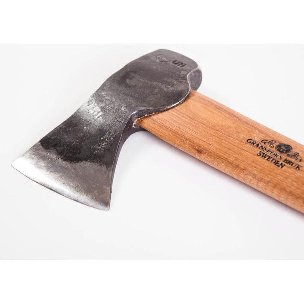 A close-up side view of the Gransfors Bruk Hunter's Axe with a wooden handle and a charcoal-colored metal head against a white background.