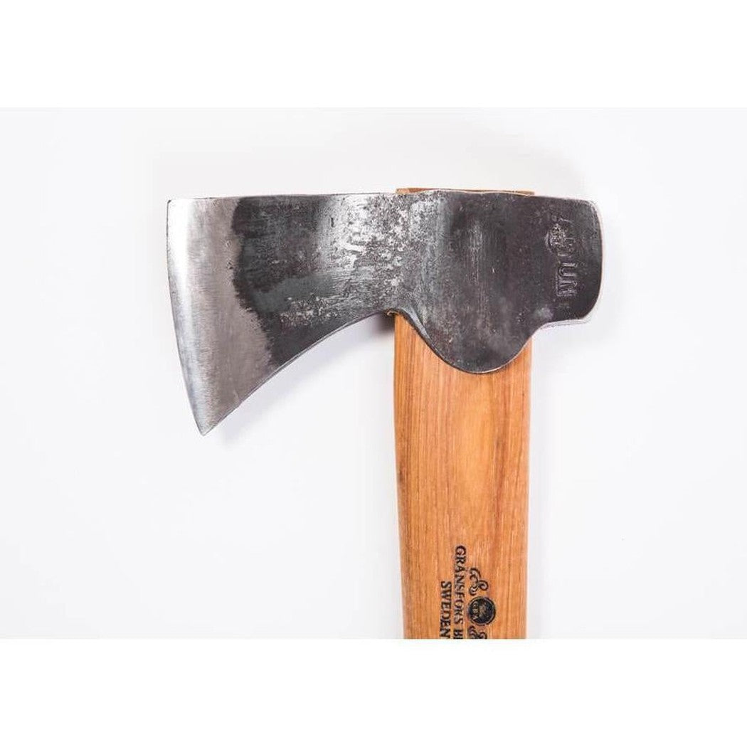 A close-up of the Gransfors Bruk Hunter's Axe with a wooden handle and a charcoal-colored blade against a white background.