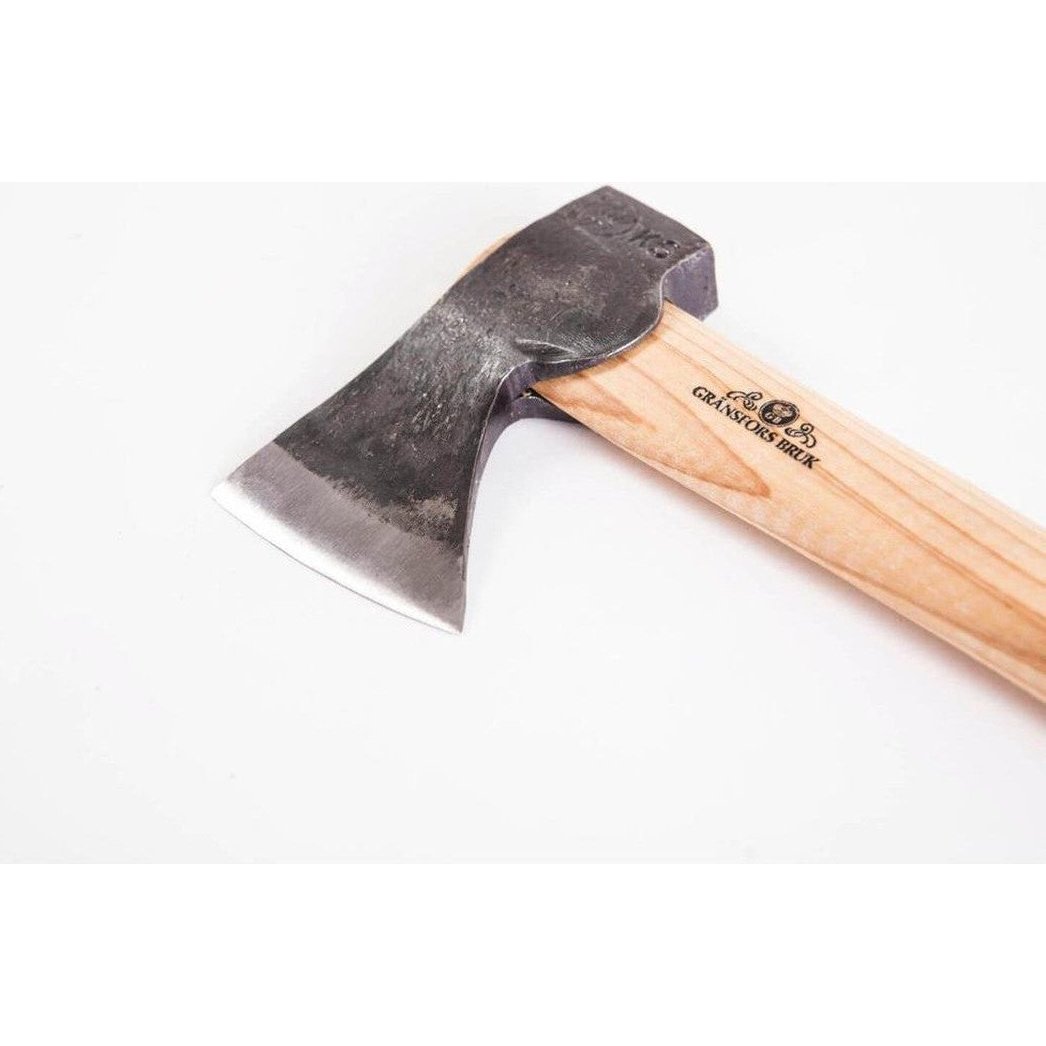 A close-up of the Gransfors Bruk Small Hatchet with its wooden handle and charcoal-colored metal head against a white background.