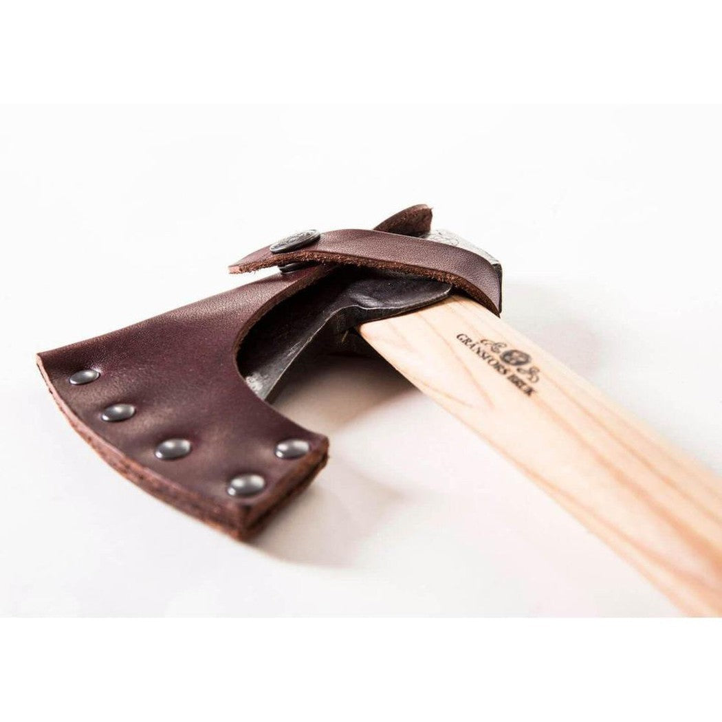 A close-up of the Gransfors Bruk Small Hatchet with a wooden handle and brown leather sheath against a white background.